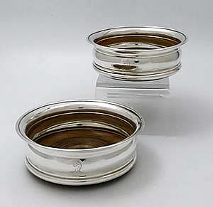 pair of English antique silver wine bottle coasters