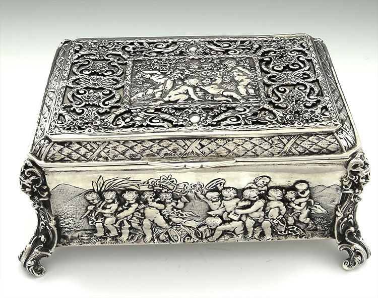 Large German 800 silver table box with chased cherubs and scenes