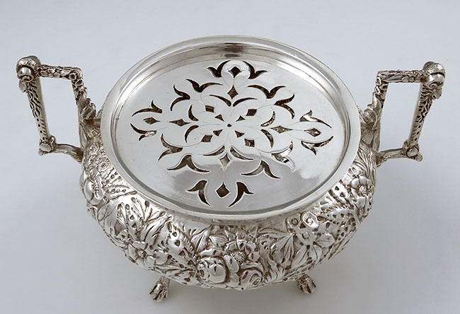 A Jacobi repousse butter dish with lion finia