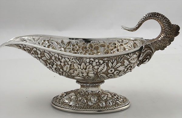 A Jacobi antique sterling repousse sauceboat with fish handle