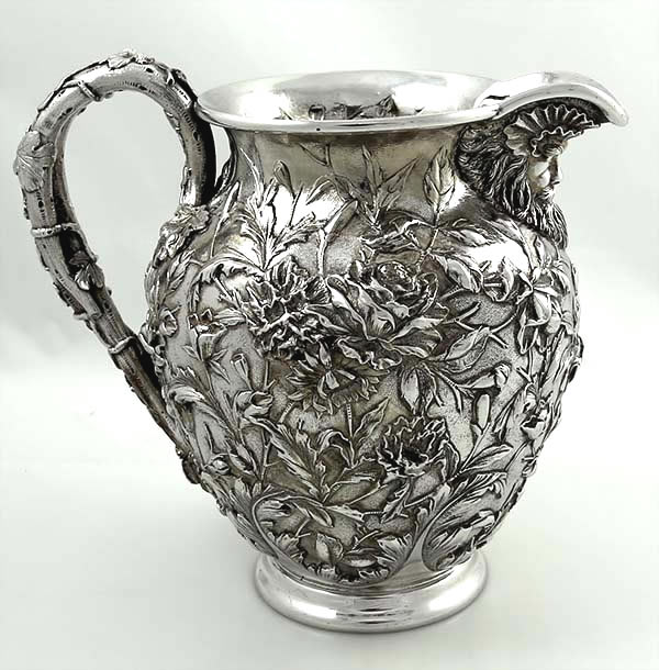 Kirk antique sterling silver pitcher with chased flowers and face spout