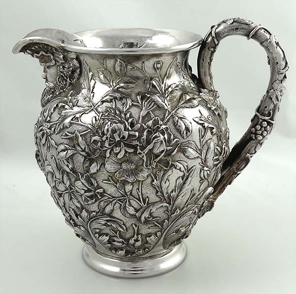 Kirk antique sterling silver pitcher with chased flowers and cast spout
