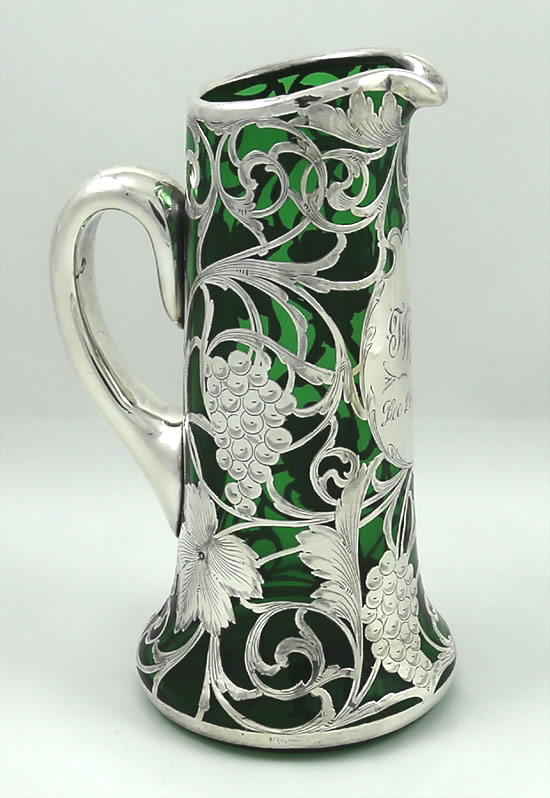 Green glass pitcher with sterling overlay