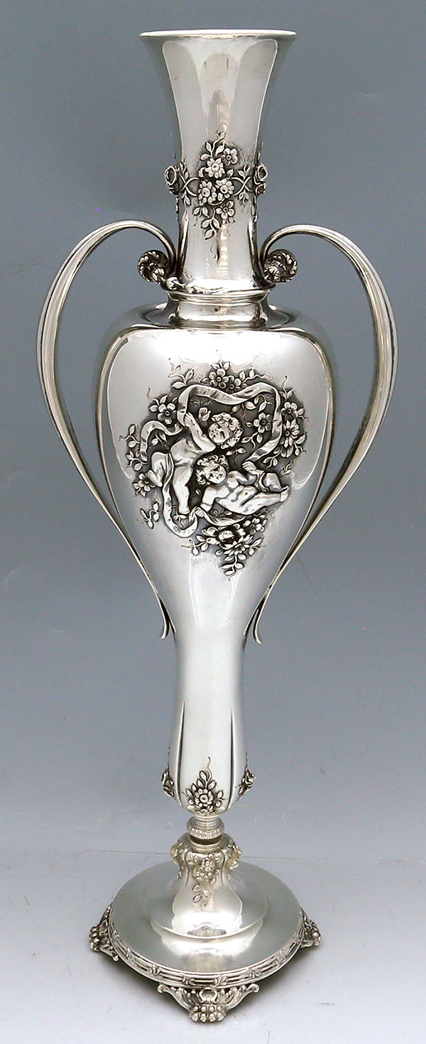 Tall Tiffany antique sterling silver vase with handles and cherubs  chased with ribbons