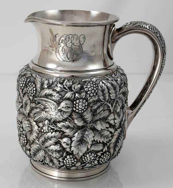 Fine antique sterling silver pitcher by Theodorre B Starr with birds and leaves against a fine stippled background
