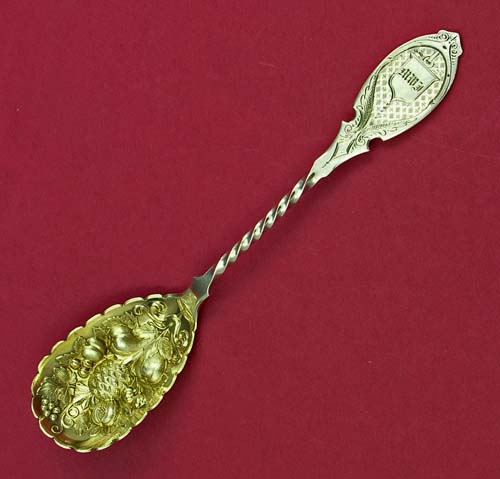 antique silver coin berry spoon with embossed bowl