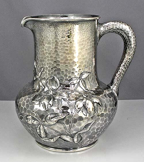 antique silver hammered pitcher with pond decoration