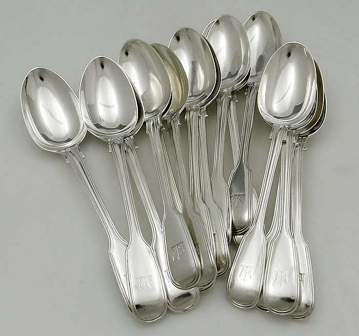 a group of English sterling silver antique dessert spoons with engraved  crests by George Adams London 1845