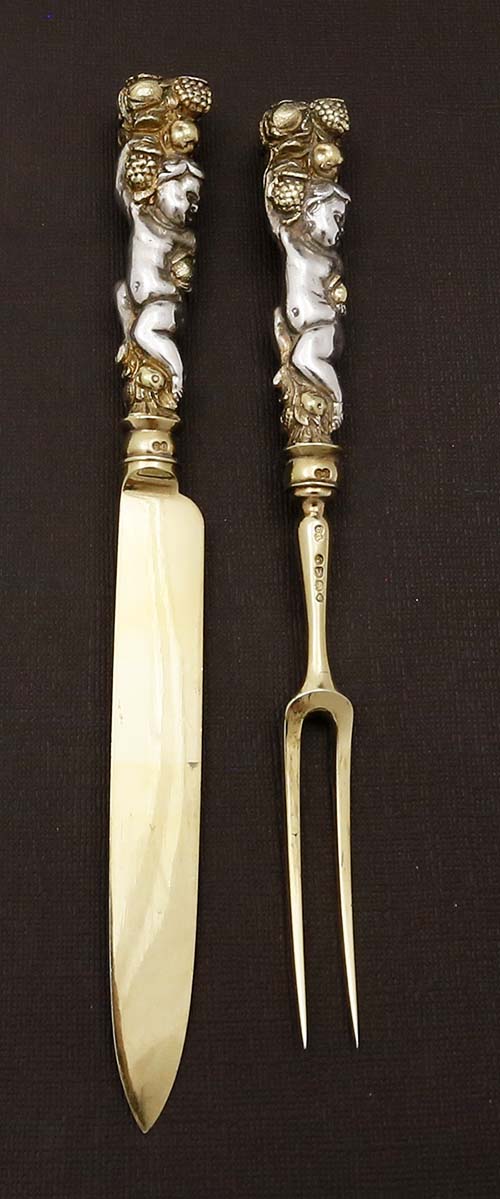 English Victorian antique silver fruit knife and fork with heavy cast cherub handle