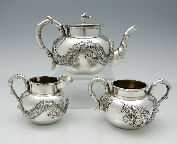three piece teaset by Luenwo with applied dragons Chinese export silver