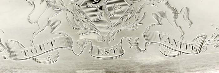 detail of engraved crests Tout Est Vanite