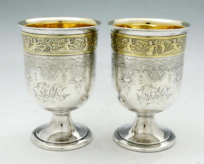 pair of Gorham antique sterling silver goblets with cupid bands and engraved satin finished surfaces