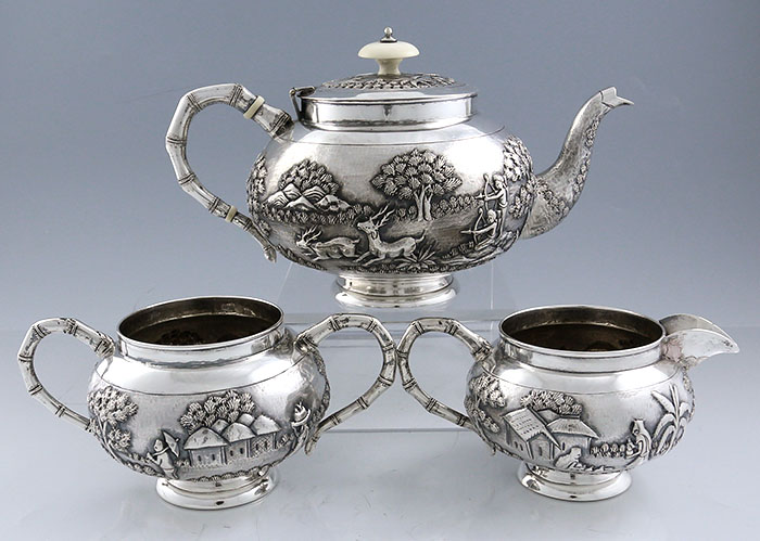 Indian silver three piece tea set with chased animals