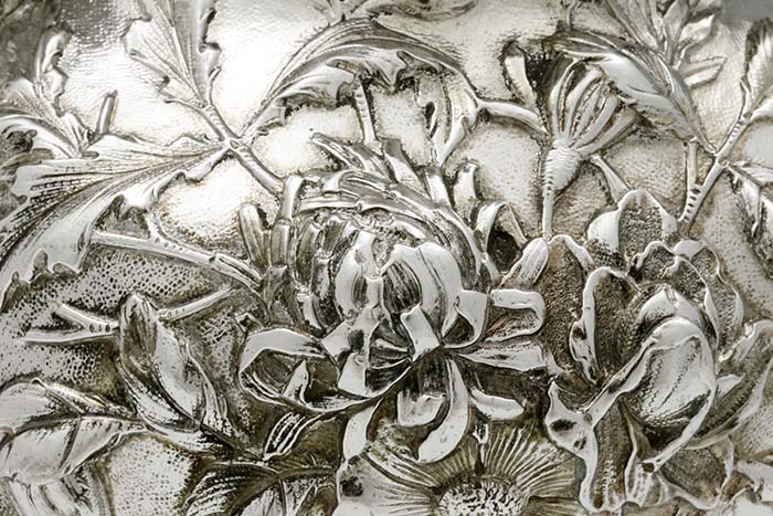 detail of repousse on pitcher