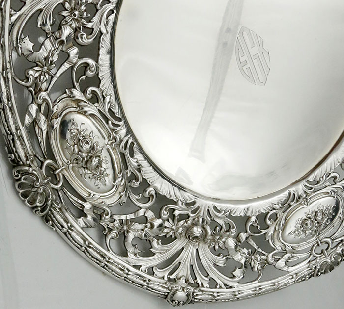 cast border of Redlich sterling silver plates