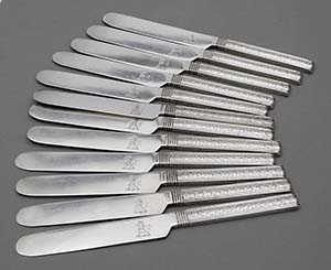 twelve matching S Kirk 1015 tea knives with engraved handles  and crest on blade