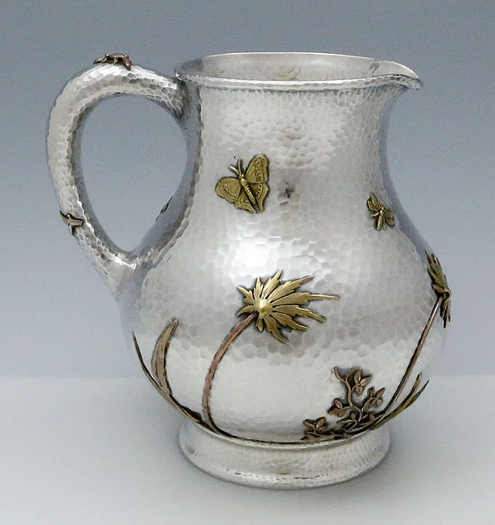Mixed metals Theodore Starr hand hammered pitcher with applied salamander