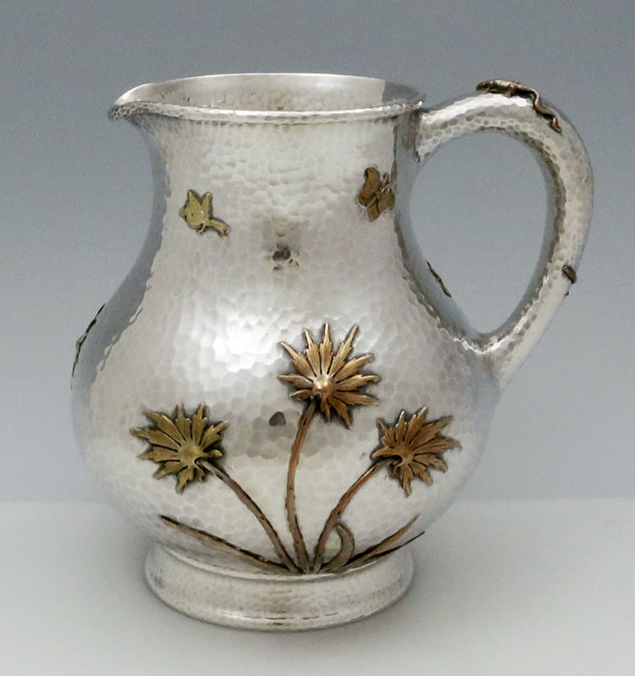Side view of Dominick & Haff hammered pitcher with applied mixed metals
