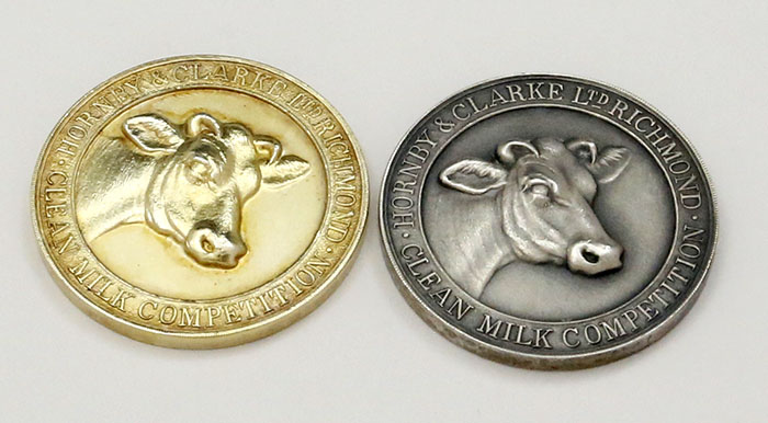 two English silver cow medals