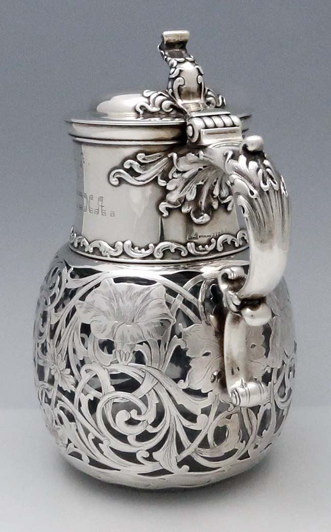 view of ornate handle on Whiting silver overlay pitcher carafe