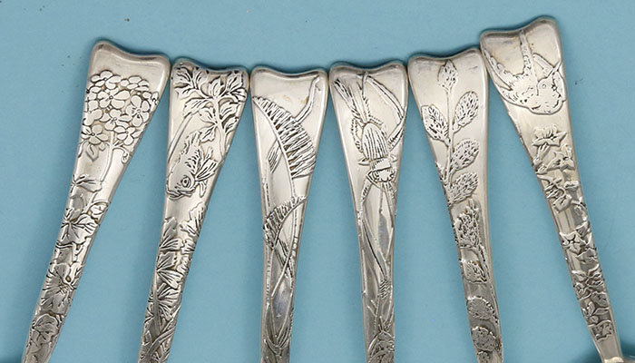 detail of the handles on Tiffany lap over edge acid etched spoons dessert